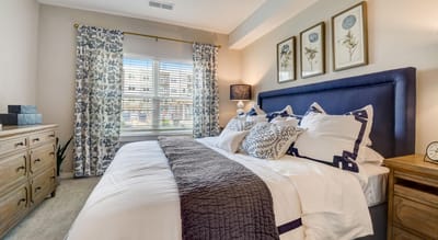 Well-furnished bedroom with floral decor and natural light