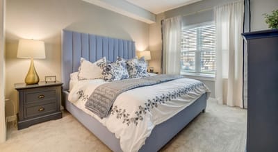A tastefully decorated resident room with a bed and lamp