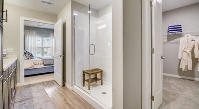 Modern bathroom with shower and closet area