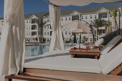 Outdoor lounge area with pool and sunbeds