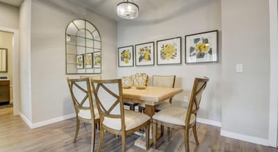 Cozy dining area with a wooden table and floral artwork