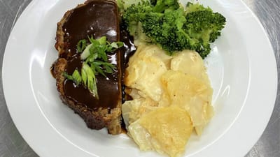 Plate of meatloaf with vegetables and potatoes
