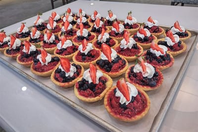 Colorful dessert tartlets arranged on a tray