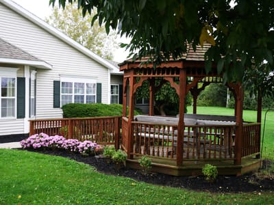 A gazebo surrounded by flowers in a green outdoor space