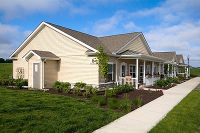 Exterior view of a senior living facility with landscaped grounds