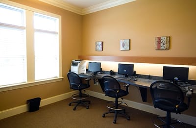 Interior photo of a computer area with desks and chairs