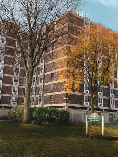 Exterior view of Glen Park Senior High Rise with trees