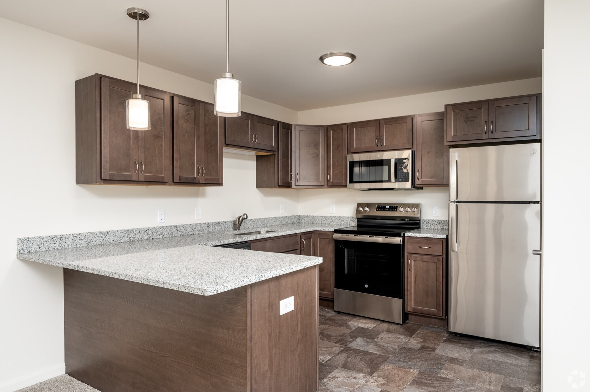 Modern kitchen with dark cabinets and stainless steel appliances