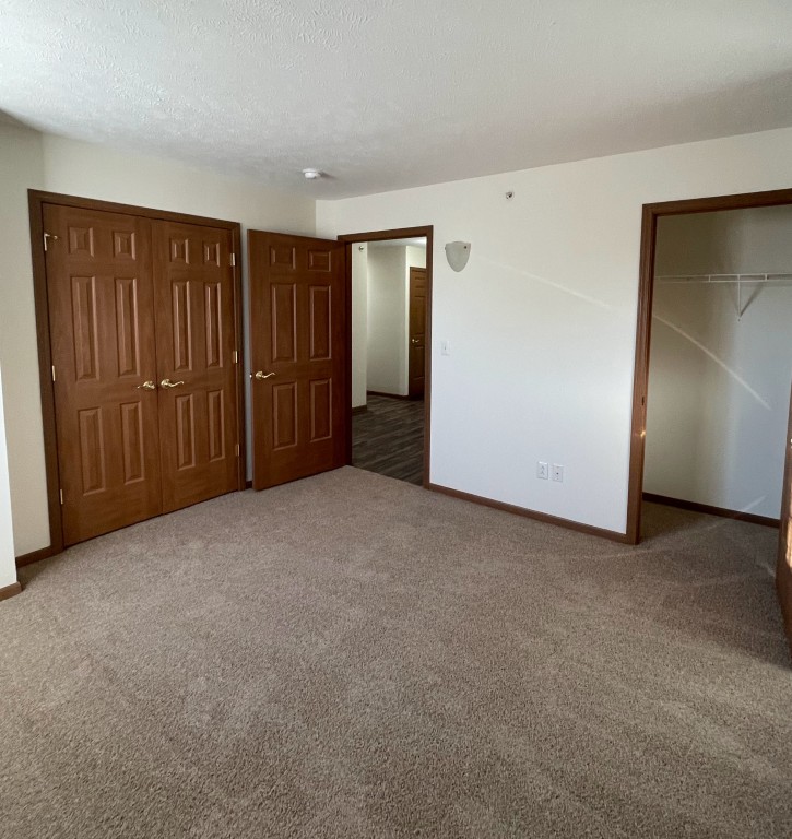 Interior view of a private resident room with carpet and doors