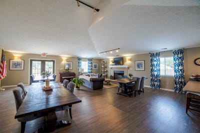 Bright common area with seating and tables for residents