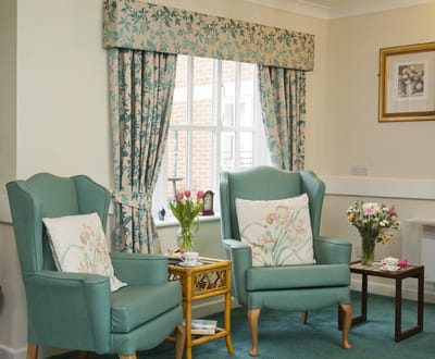 Cozy seating area with floral curtains and decor