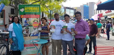 Group of people engaging in promotional activity outdoors.