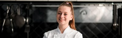 Chef smiling in a kitchen setting