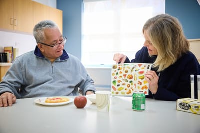 Staff member engaging with resident during an activity.