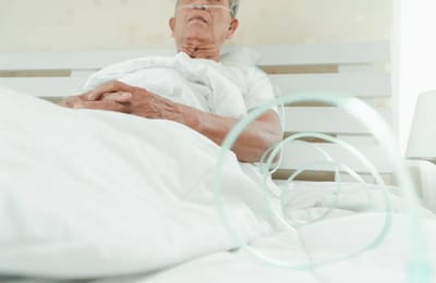 Elderly man resting in a hospital bed