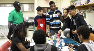 Group of young people engaged in an activity indoors.