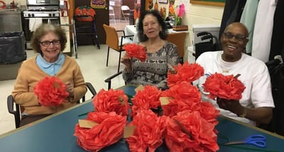 Residents making crafts together in a common area.