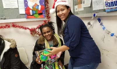 Residents participating in a holiday event with gifts.