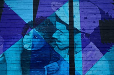 Colorful mural depicting a parent and child.