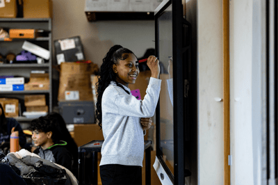 Young woman interacting with a digital board