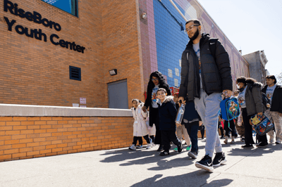 Group of people walking outside a community center