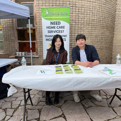 Two representatives at a community event booth.