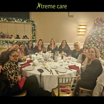 Group of staff gathered around a festive dining table.