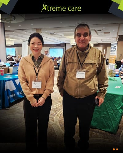 Two staff members posing in a common area.
