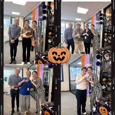Staff and residents celebrating Halloween in common area.
