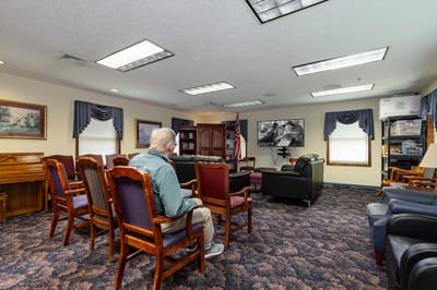 Common area with chairs and an individual seated