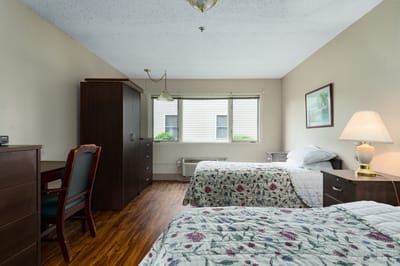 Two beds in a shared resident room