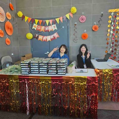 Staff members at a festive event with food presentation.