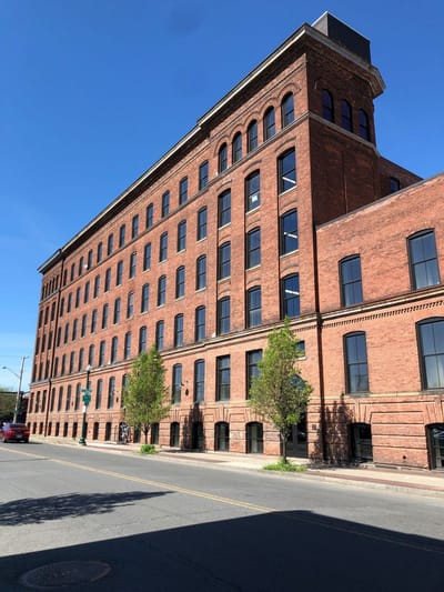 Exterior of a brick building under a blue sky.