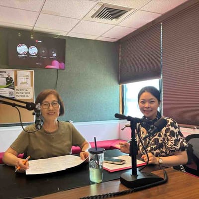Two women talking in a studio setting.