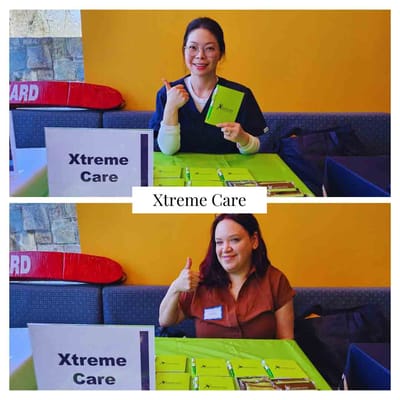 Staff members at a promotional table for Xtreme Care