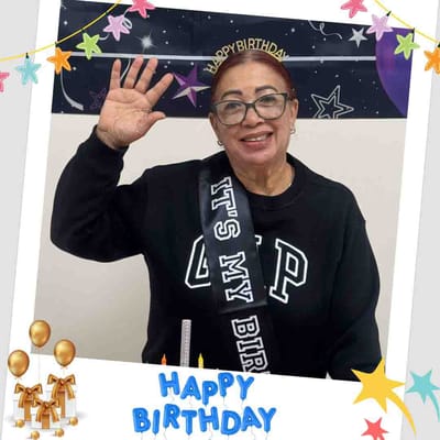 Resident celebrating a birthday with a sash
