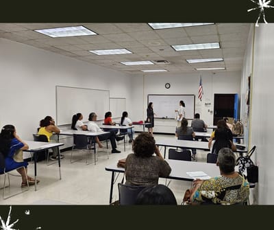 Group of people attending a class in a classroom setting.