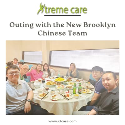Residents enjoying a meal with staff at a dining table.