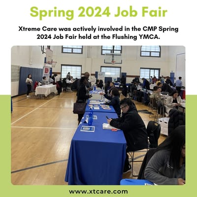 Job fair with tables and attendees at a gymnasium.