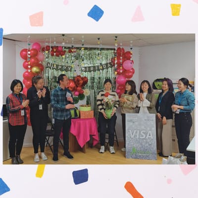 Staff celebrating a birthday with decorations and gifts.