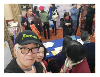Group of people in a common area with an event backdrop.