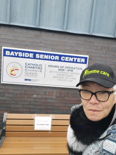Person in front of a senior center sign.