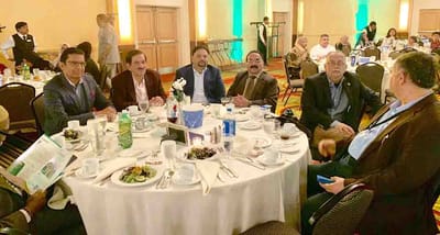 Group of people dining and engaging socially.