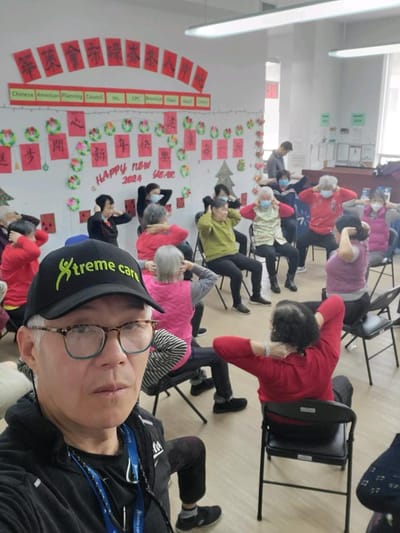 Residents participating in a seated exercise class