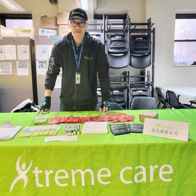 Staff member at a table with promotional materials.