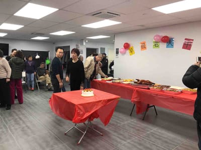Residents enjoying food and activities during a celebration.