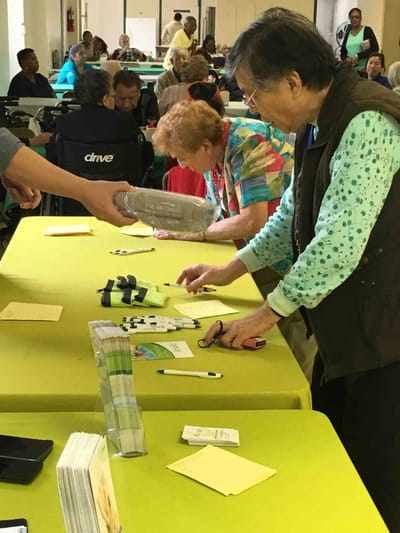Residents participating in an activity at a shared table.