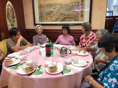 Residents enjoying a meal at a dining table