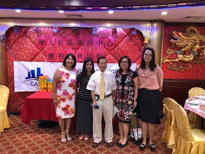 Group of staff and visitors at a celebration.