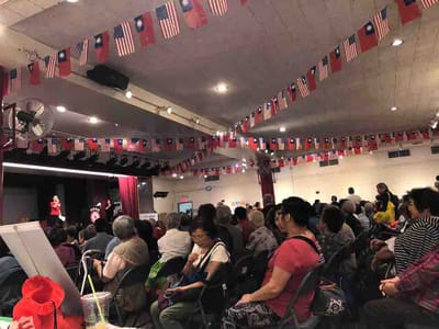 Crowd at an event decorated with flags